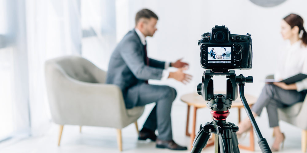 selective focus of digital camera shooting journalist and businessman